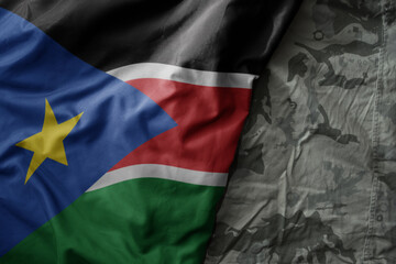 waving flag of south sudan on the old khaki texture background. military concept. - obrazy, fototapety, plakaty