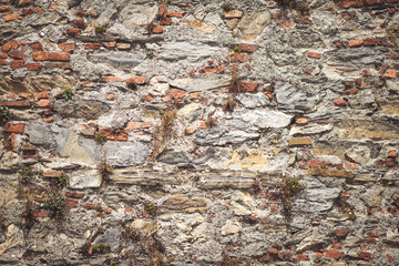 Close up shot of a beautifully textured dry stone wall. Pattern Vintage Color Texture of Modern Style Design Decorative Uneven Cracked Real Stone Wall Surface with Cement for Construction Work.