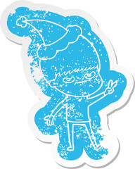 annoyed quirky cartoon distressed sticker of a boy wearing santa hat