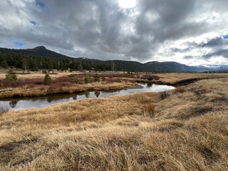 mountain landscape with river and clouds