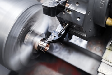 Close-up of turning work on a machine, turning a metal workpiece. Motion blur