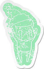 quirky cartoon distressed sticker of a man crying wearing santa hat