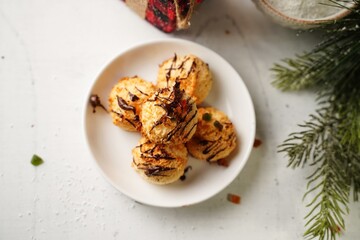 Homemade Coconut macaroons with chocolate drizzle on holiday background, selective focus