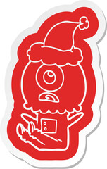 quirky cartoon  sticker of a cyclops alien spaceman wearing santa hat