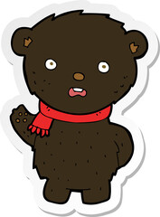sticker of a cartoon black bear wearing scarf
