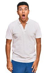 Young arab man wearing casual clothes afraid and shocked with surprise and amazed expression, fear and excited face.