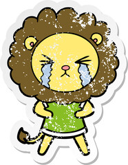 distressed sticker of a cartoon crying lion