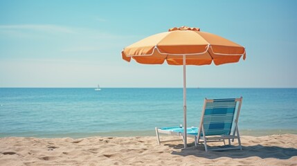 A beach chair and an umbrella on the beach.