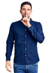 Fototapeta premium Young handsome man wearing casual shirt asking to be quiet with finger on lips. silence and secret concept.