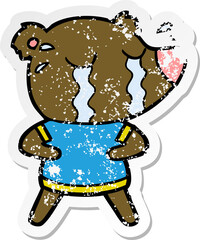 distressed sticker of a cartoon crying bear