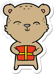 sticker of a happy cartoon bear with gift