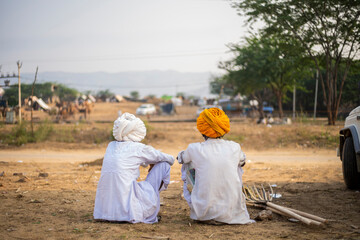 Two elderly people sitting next to each other in Pushkar Mela