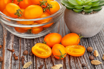 orange plum cherry tomato on wood background