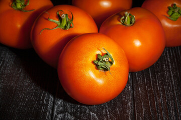 orange tomato on wood background