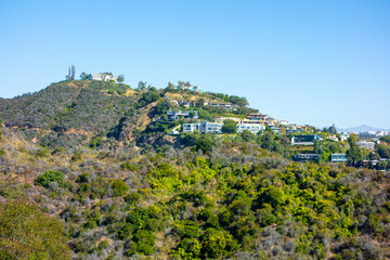 Fototapeta na wymiar Mandeville Canyon Neighborhood with large houses in the hills of the Santa Monica Mountains. Dennis Tito’s house sits atop of the hilltop.