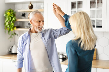 Obraz premium Portrait Of Active Senior Couple Dancing Together At Home