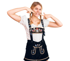 Young beautiful blonde woman wearing oktoberfest dress smiling cheerful showing and pointing with fingers teeth and mouth. dental health concept.