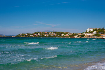 Closeup of sand on beach and blue summer sky. Panoramic beach landscape. Empty tropical beach and seascape