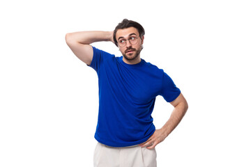 young smart caucasian brunette man with stylish haircut and beard in blue t-shirt thinking about idea and strategy. brainstorm