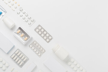 Flat lay with different pills in blister packaging and boxes and on color background