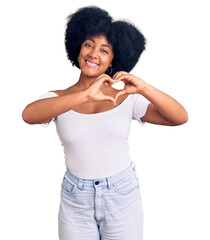 Young african american girl wearing casual clothes smiling in love showing heart symbol and shape with hands. romantic concept.