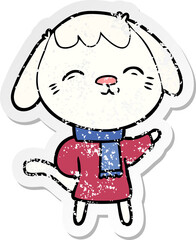 distressed sticker of a happy cartoon dog in winter clothes