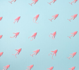 Pattern of pink bugs on blue background. Pastel, natural concept. Fishing lures.