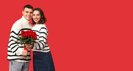 Happy young couple with bouquet of beautiful roses on red background with space for text. Valentine's Day celebration