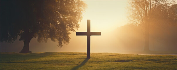 Crucifix in morning light agaisnt green autumn forest.
