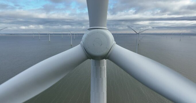 Close up view of the rotor blades of an Offshore wind turbine wind park.
