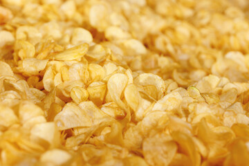 Fresh Crispy potato chips snack texture background with sun light, top view