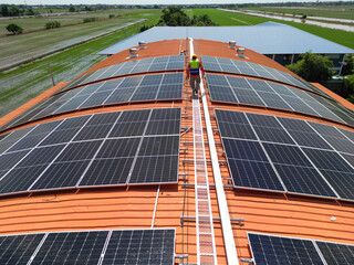 engineer man inspects construction of solar cell panel or photovoltaic cell at roof top. Industrial...