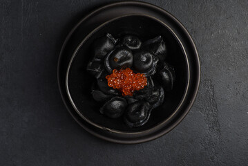 black dumplings with red caviar