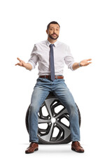 Unhappy man sitting on a flat car tire