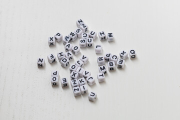 Small white cubes with the letters of the alphabet on them.