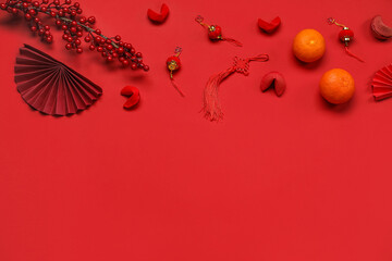 Obraz premium Composition with Chinese symbols, fortune cookies and tangerines on red background. New Year celebration
