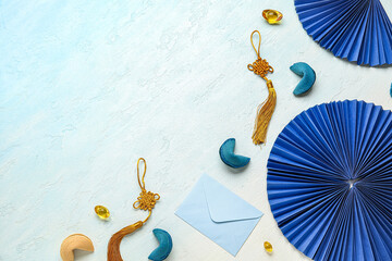 Composition with Chinese symbols, fortune cookies and envelope on light background. New Year...