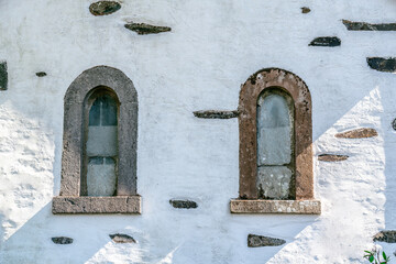 traditional mediterranean white building exterior with two arched windows
