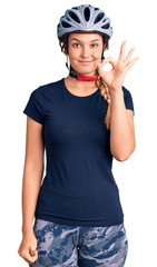 Beautiful caucasian woman wearing bike helmet smiling positive doing ok sign with hand and fingers. successful expression.