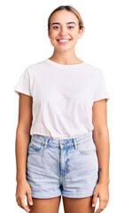 Obraz premium Young beautiful blonde woman wearing casual white tshirt with a happy and cool smile on face. lucky person.