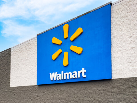 EATONTON, GEORGIA - DECEMBER 6 2023 : Exterior view of Walmart store logo sign. Founded by Sam Walton in 1962, Walmart operates a chain of discount retail and grocery stores.