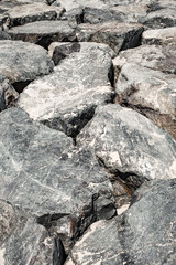 stones boulders are huge piled up in close-up gray