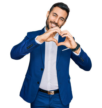 Young hispanic man wearing business jacket smiling in love doing heart symbol shape with hands. romantic concept.
