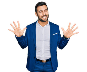 Young hispanic man wearing business jacket showing and pointing up with fingers number ten while smiling confident and happy.