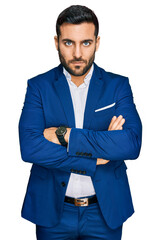 Young hispanic man wearing business jacket skeptic and nervous, disapproving expression on face...