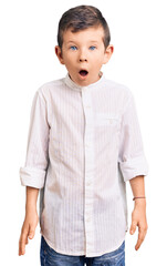 Cute blond kid wearing elegant shirt afraid and shocked with surprise and amazed expression, fear and excited face.