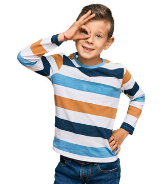 Adorable caucasian kid wearing casual clothes smiling happy doing ok sign with hand on eye looking through fingers