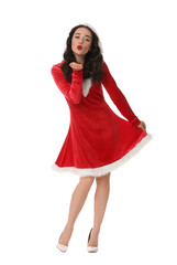 Beautiful young woman in Christmas red dress blowing kiss isolated on white