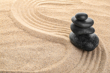 Fototapeta na wymiar Zen stones in the sand, zen concept, harmony and balance