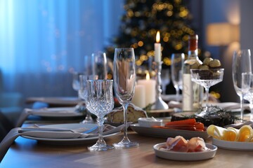 Christmas table setting with festive decor and dishware indoors